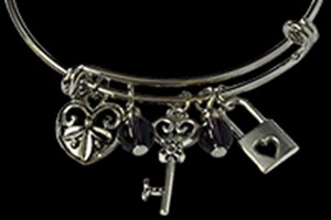 Silver bracelet featuring beads, key and lock